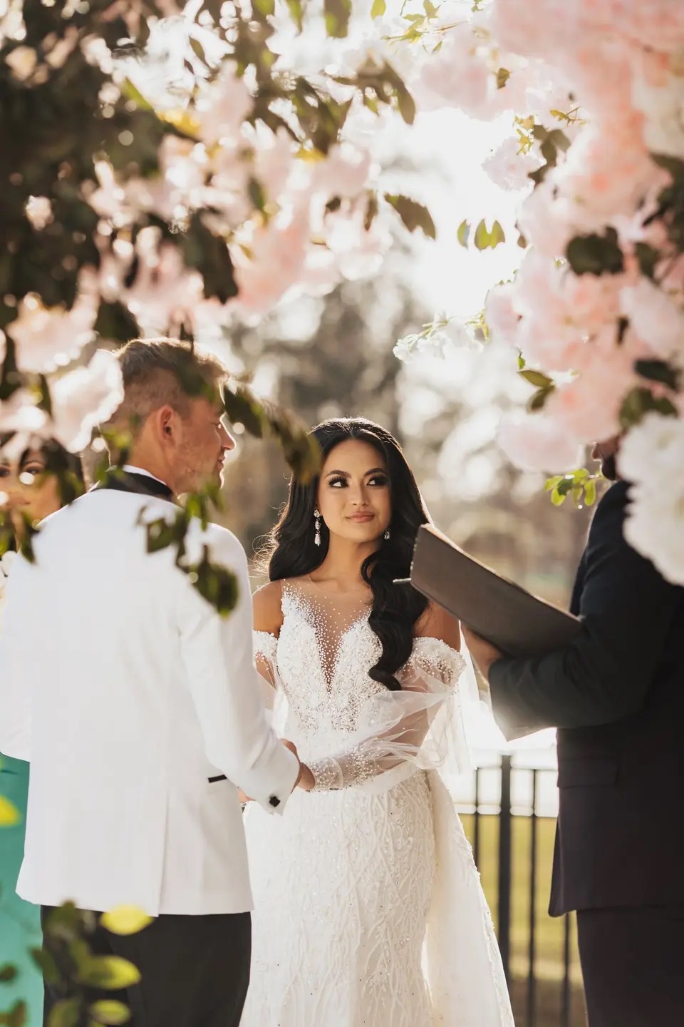 Bride framed by soft blush florals during her ceremony