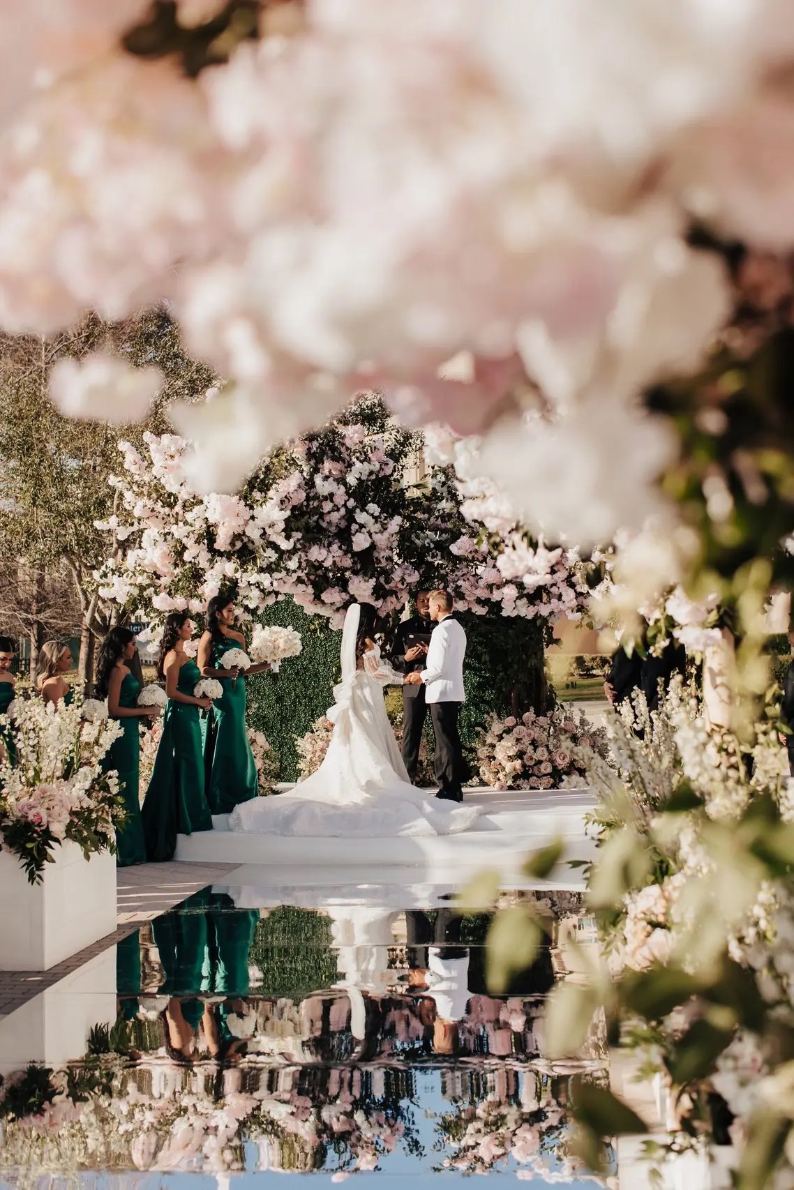 Luxury floral wedding ceremony reflected in a mirrored aisle
