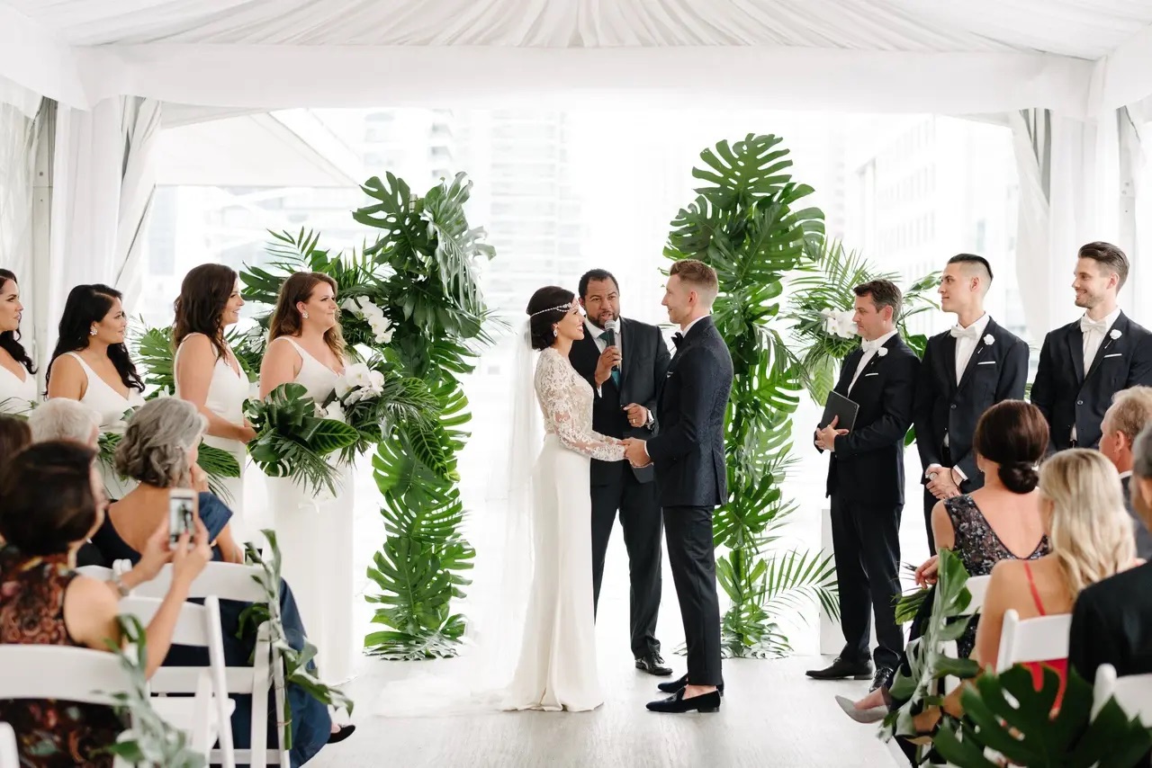 Wayde officiating a bright tropical wedding ceremony