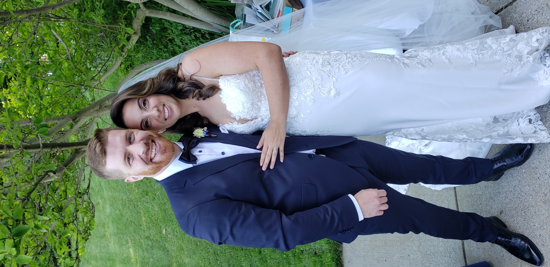 Newlyweds smiling together after a garden ceremony