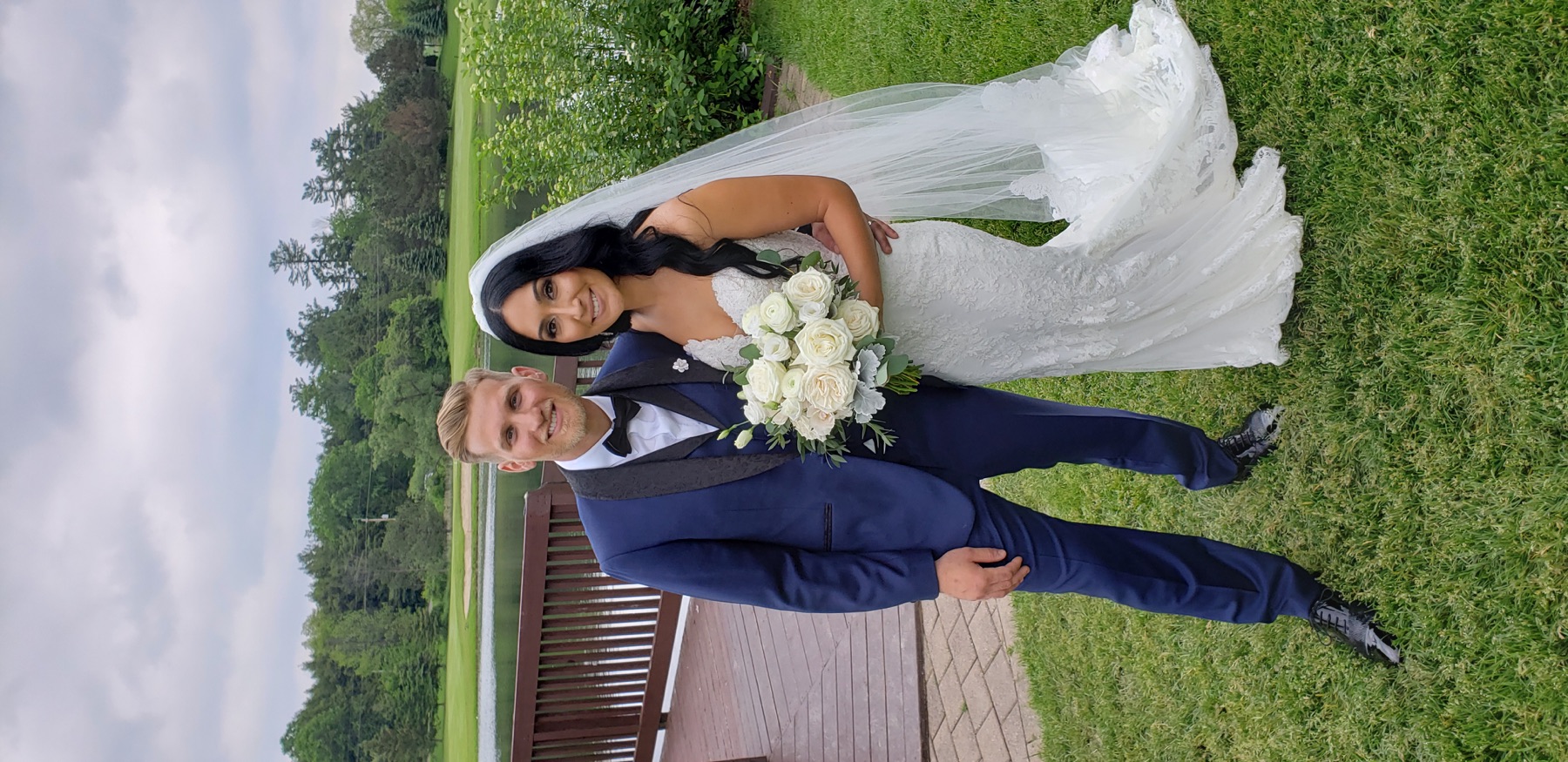 Newlyweds together beside the lake