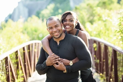 Wayde and his wife sharing a joyful portrait outdoors