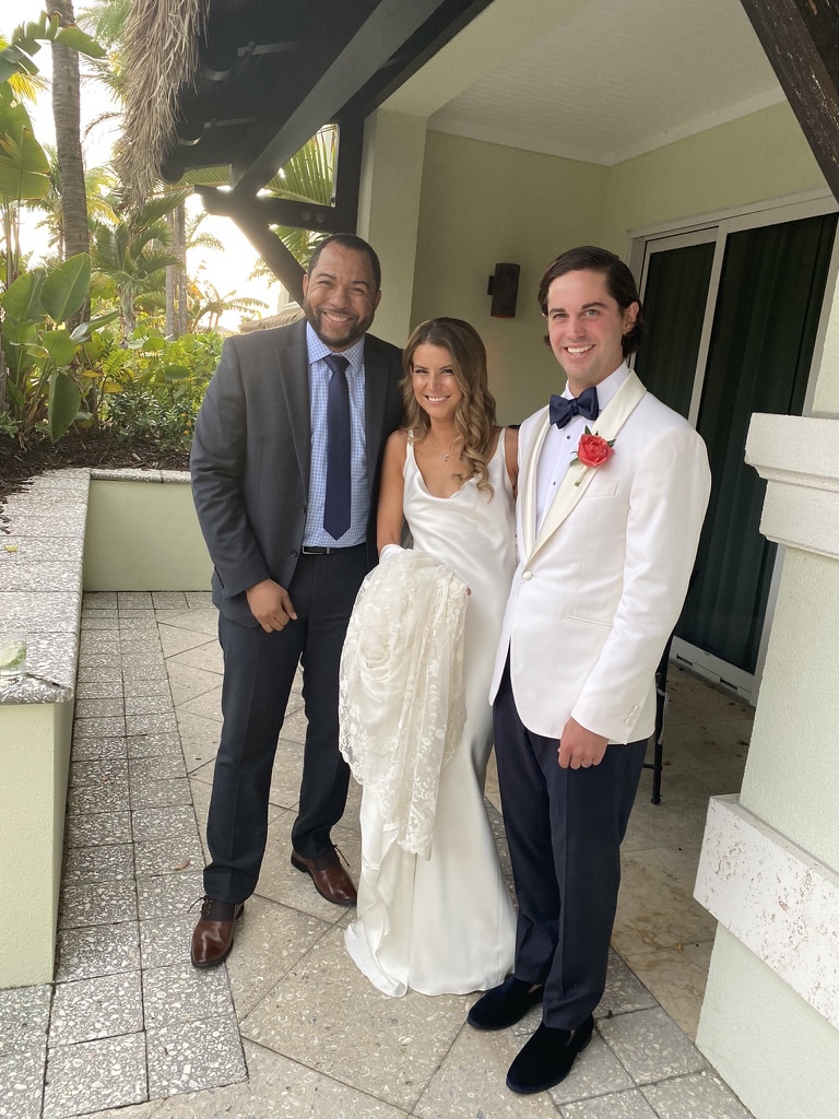 Wayde with newlyweds at a destination wedding