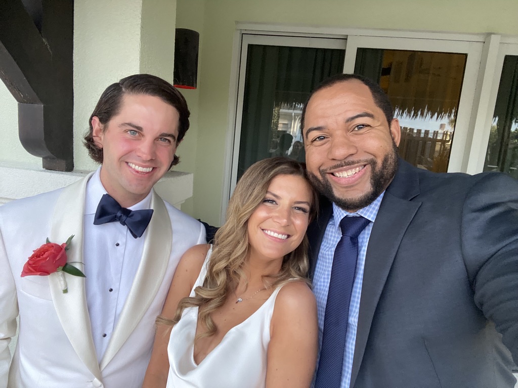Wayde sharing a joyful selfie with a destination-wedding couple