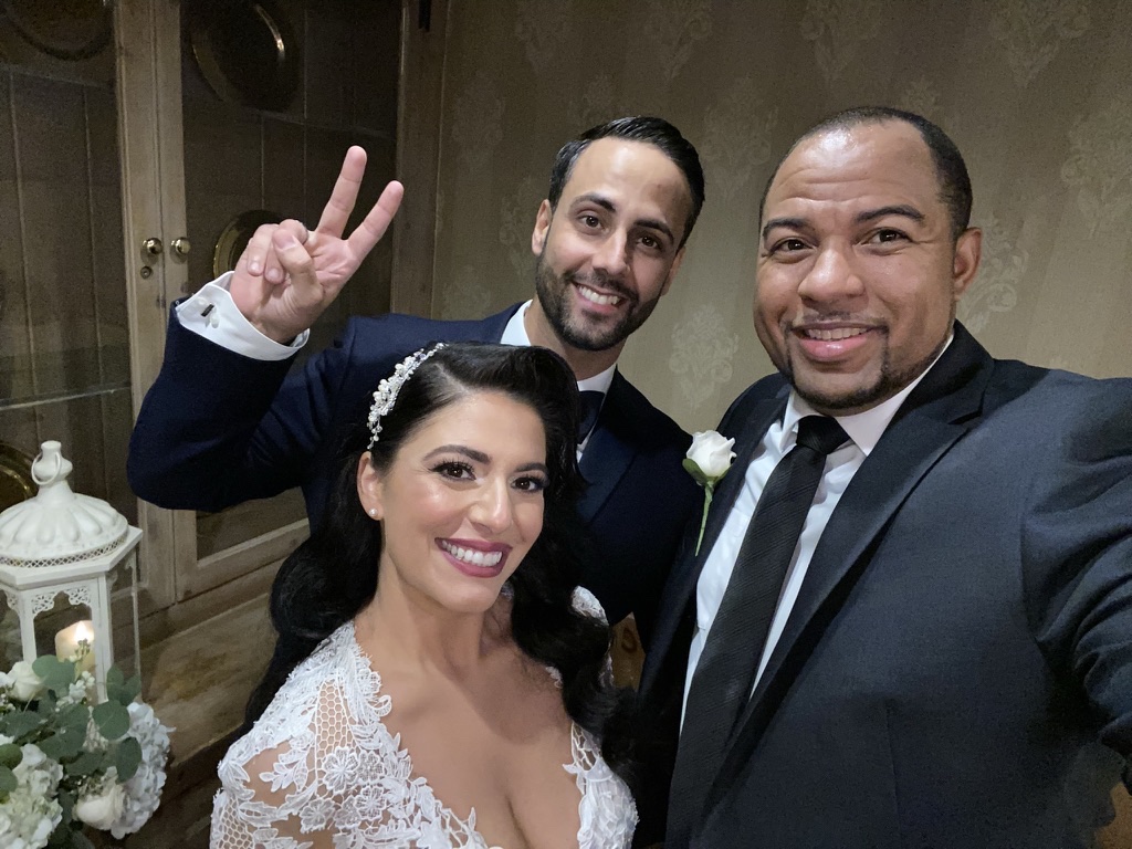 Wayde taking a playful selfie with newlyweds
