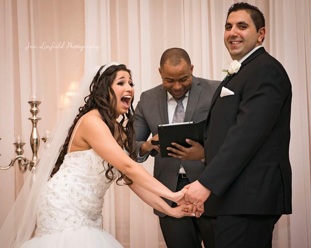 Wayde sharing a lighthearted moment during an indoor ceremony